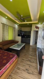 a living room with a couch and a table at M2 lambardaar in Dehradun