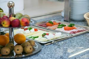 a buffet with several trays of food on a counter at Jugendhaus St. Kilian in Miltenberg