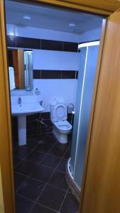 a bathroom with a toilet and a sink at Porto Bistro in Baku