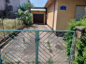 a gate in front of a building with a door at Marinel in Vršac