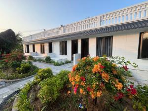 a building with flowers in front of it at Sea DoSon Resort in Ðố Sơn +20 photos