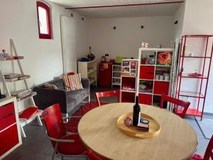 a living room with a table with a wine bottle on it at Rotes Haus im Havelland in Phöben