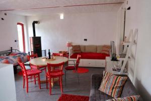 a living room with a table and chairs and a couch at Rotes Haus im Havelland in Phöben