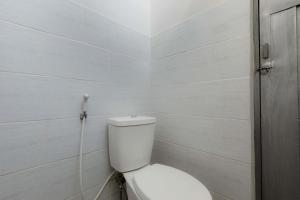 a white bathroom with a toilet in a room at Agni Homestay in Yogyakarta +12 photos