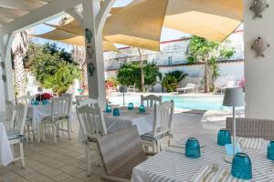 a restaurant with a table and chairs and a pool at Marechiaro Pool & Restaurant in Paestum