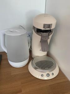 a coffee maker sitting on a counter next to a mixer at Eifelliebe in Bergweiler