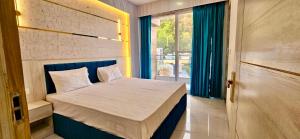 a small bedroom with a bed and a window at Yogvan Luxury 1BHK Apartments Tapovan Rishikesh in Rishīkesh