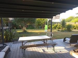 a picnic table and chairs on a patio at Guest House Erdeven in Erdeven