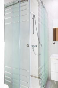 a shower with a glass door in a bathroom at Rush Inn Hotel in Astana +73 photos
