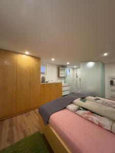 a bedroom with a large bed and a kitchen at Thalerhof-Markus in Roppen