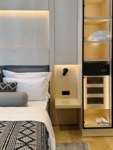 a bedroom with a bed and some shelves at MrSTiL Design Aparthotel in Berlin