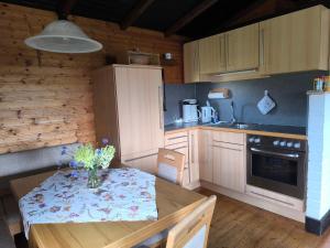 a kitchen with a table with a vase of flowers on it at Ferienhaus Schallerhof in Kupferberg