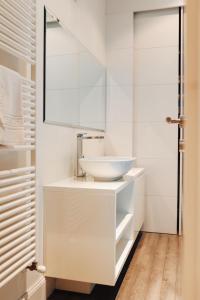 a white bathroom with a sink and a mirror at Appartamento in Piazza a Bevagna in Bevagna +21 photos