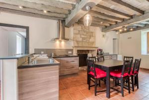 a kitchen with a table and chairs and a sink at Valfermet 5 personnes in Mauvilly