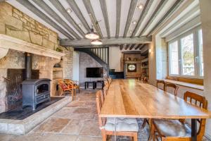 a large room with a wooden table and a fireplace at Valfermet 5 personnes in Mauvilly
