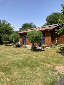 a brick house with a yard in front of it at Crisalys Chambres d'Hôtes in Pessac