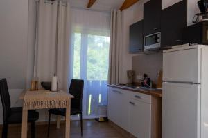 a small kitchen with a table and a refrigerator at Hof Bahrenwinkel in Osterholz-Scharmbeck