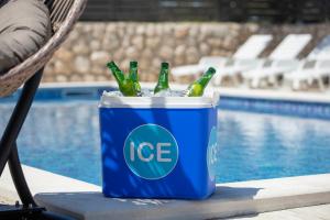 a blue ice bucket filled with bottles of beer at BUDGET RESORT Vagabundo in Novalja