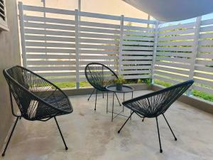 a patio with two chairs and a table with a plant at Lucca&Joy Apartment in Lucca