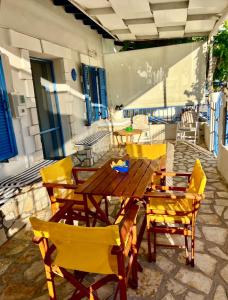 a wooden table and chairs on a patio at Joanna Seaside House in Meganisi