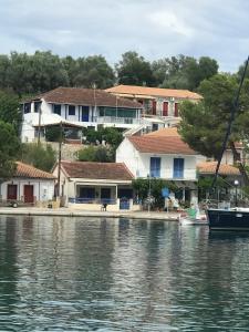 a group of houses next to a body of water at Joanna Seaside House in Meganisi
