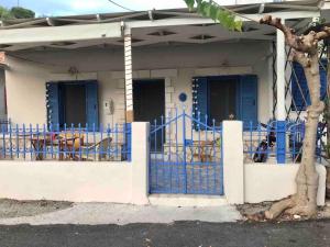 a house with blue doors and a blue fence at Joanna Seaside House in Meganisi