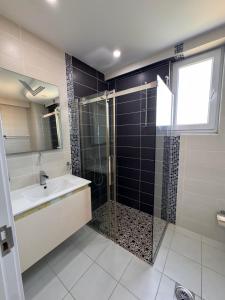 a bathroom with a shower and a sink and a glass shower door at SunsetEscape Apartments Utjeha in Utjeha +8 photos