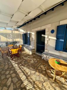 a patio with tables and chairs on a building at Joanna Seaside House in Meganisi +63 photos