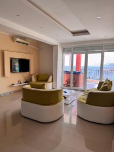 a living room with two couches and a television at SunsetEscape Apartments Utjeha in Utjeha