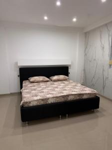 a bedroom with a bed in a white room at SunsetEscape Apartments Utjeha in Utjeha