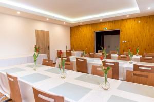 a conference room with white tables and chairs at Penzión Stálica in Bojnice