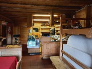 a kitchen with wooden cabinets and a counter in a room at Rifugio Plan Boè in Livinallongo del Col di Lana