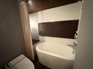 a bathroom with a toilet and a tub and a sink at HOTEL Clam Chowder in Kyoto +90 photos