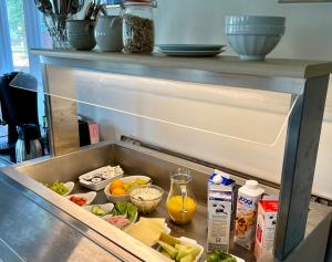 a drawer in a refrigerator filled with food at Husby Wärdshus in Dala Husby