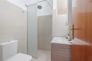 a bathroom with a toilet and a sink and a shower at Dorothy's Seaview Apartment in Haraki +24 photos
