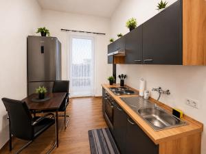 a kitchen with a sink and a counter with a table at Bright and Elegant Private Room in Dresden