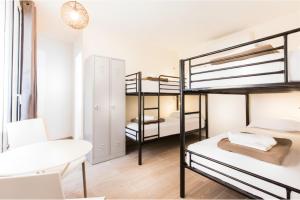a bedroom with bunk beds in a hostel at Enjoy Hostel in Paris
