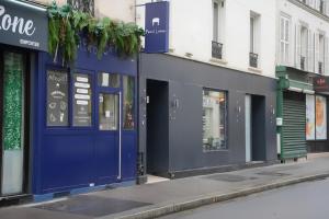 a row of store fronts on a city street at Enjoy Hostel in Paris