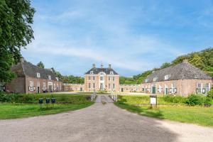 a large brick building with a road in front at Zwaluwenburg 8 in 't Harde