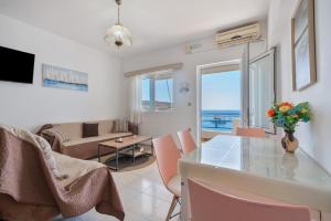 a living room with a table and chairs and a couch at Dorothy's Seaview Apartment in Haraki