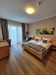 a bedroom with a bed and a chair in a room at Gasthof Wachter in Gaal