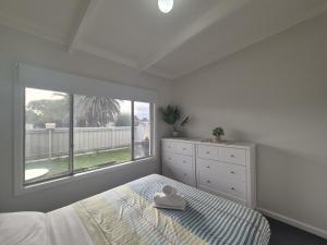 a bedroom with a bed and a large window at Esperance Little Units 3 in Esperance