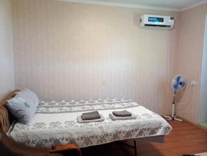 a bedroom with a bed with two towels on it at Дом-House в Vadul lui Voda in Vadul lui Vodă