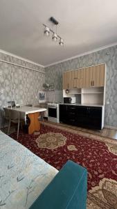 a room with a kitchen with a table and a dining room at Eneshka- дача in Dolinka