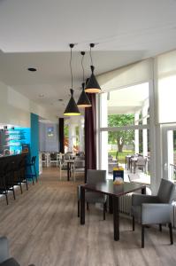 a lobby with a table and chairs and tables and chairs at HI Hostel Dunepanne in De Haan