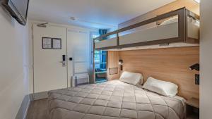 a bedroom with a large bed in a room at Premiere Classe Biarritz in Biarritz