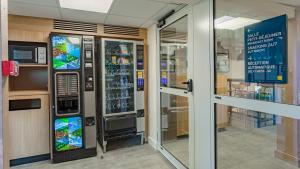 a vending machine in a building with a window at Premiere Classe Biarritz in Biarritz