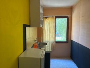 a small kitchen with a sink and a window at Морска База Венера in Tsarevo