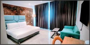 a hotel room with a bed and a couch at Regenta Waterfront Resort, Dapoli in Dapoli