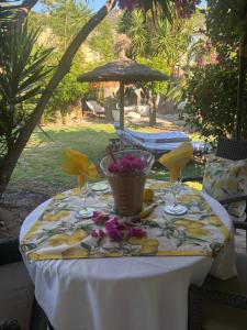 a table with a white table cloth and flowers on it at Casita Limón Andratx in Andratx
